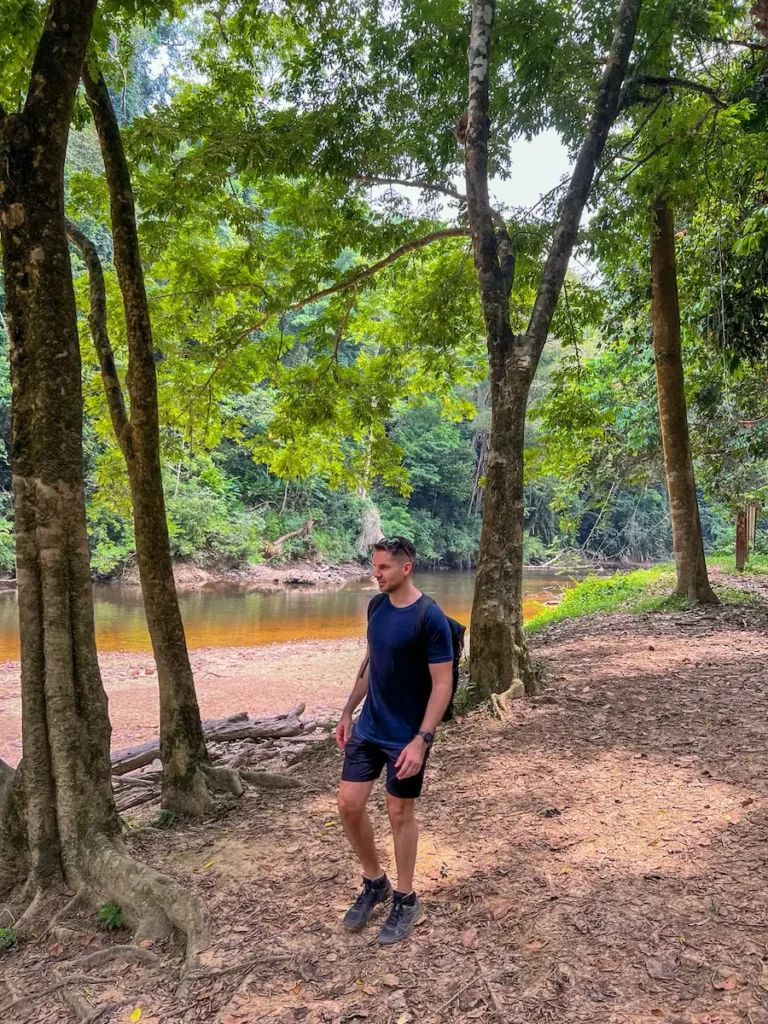 Guillaume hiking by the river